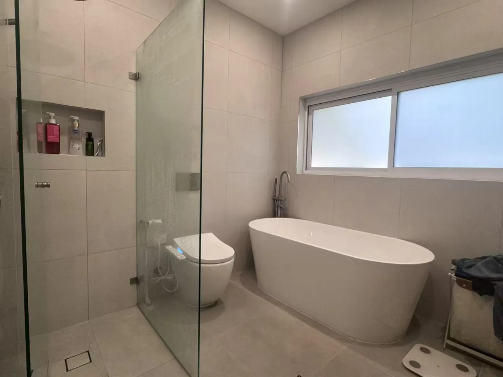 Completed Turramurra bathroom with a freestanding bath, glass shower screen and tiled walls