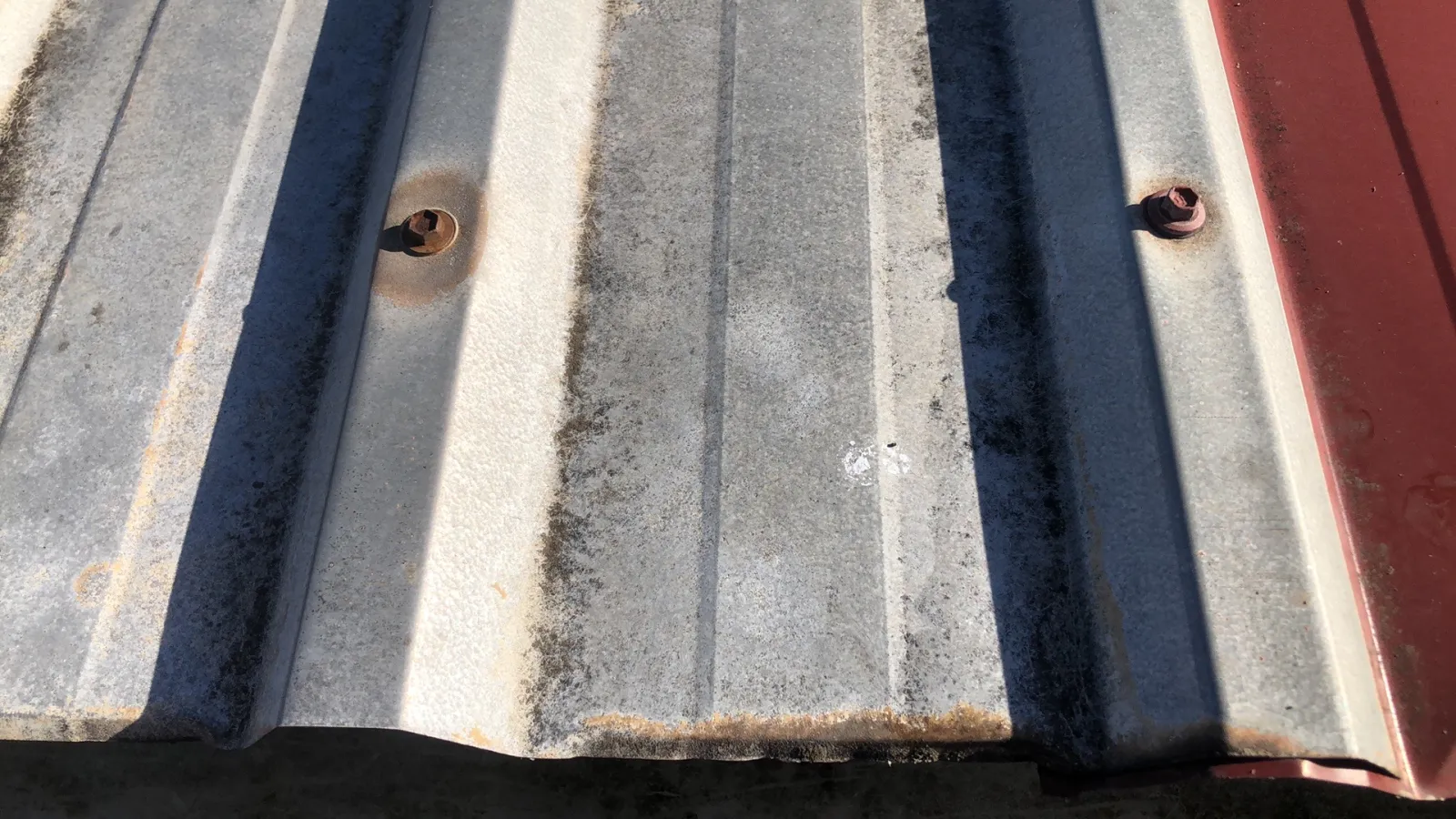 Existing corrugated roof sheets and fasteners documented before work at the St Clair project