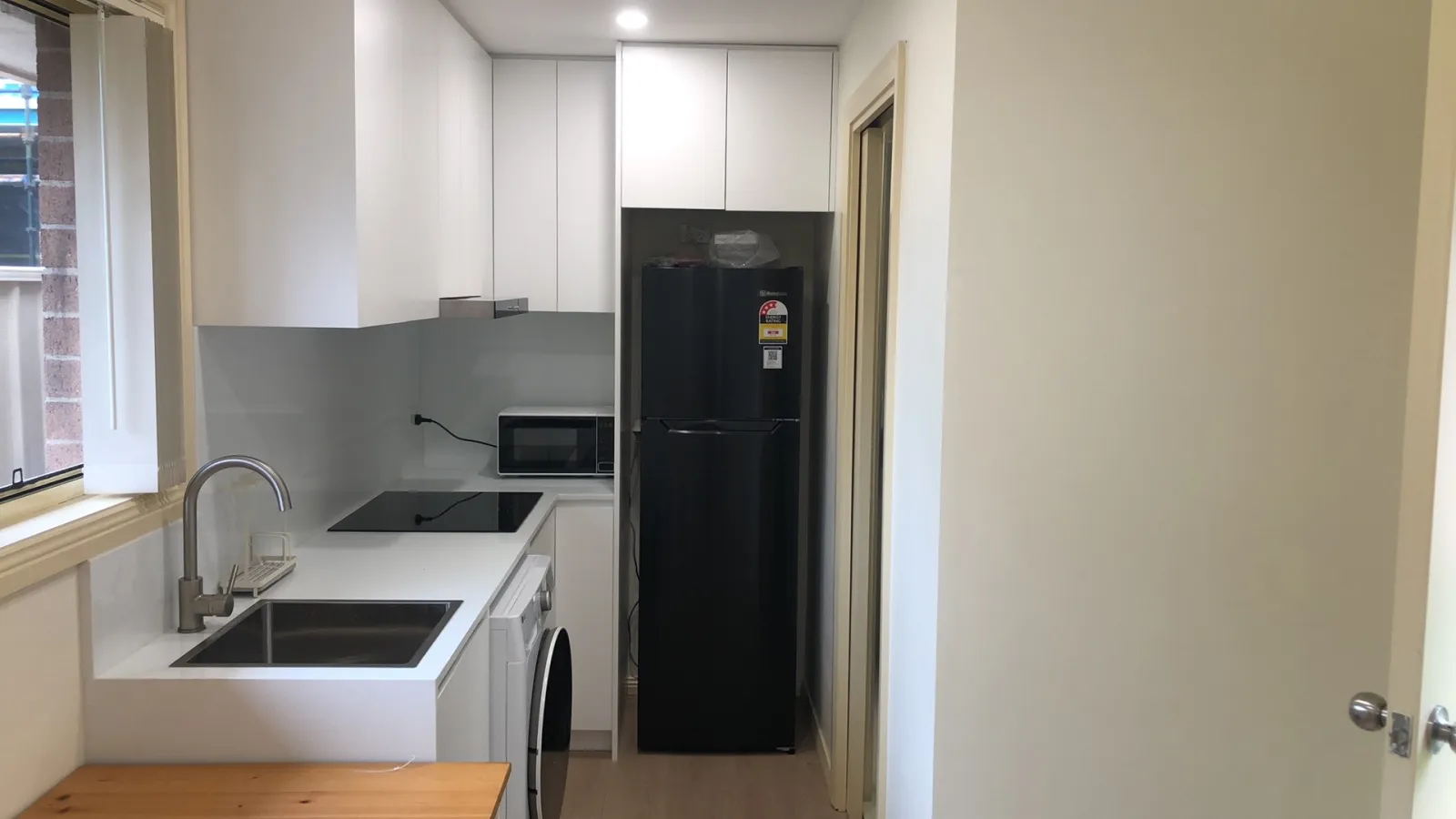 Completed compact kitchen and laundry area in the Zokoon Eastwood project